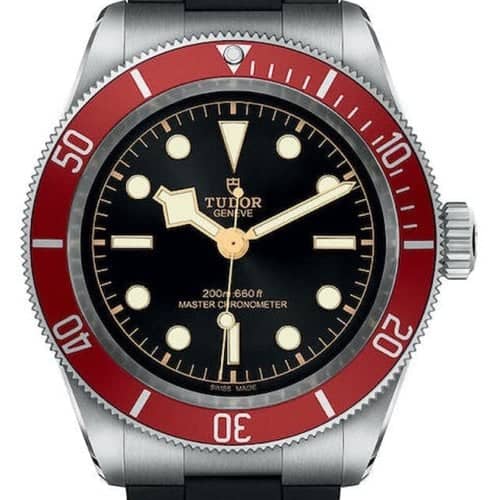 A Tudor Genève wristwatch with a red and silver rotating bezel, black dial, luminous hour markers, and a black strap. The watch face displays "MASTER CHRONOMETER" and depth rating.