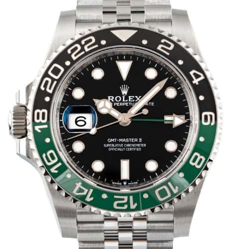 A Rolex GMT-Master II watch with a black and green bezel, black dial, silver bracelet, and date display at the 9 o'clock position.
